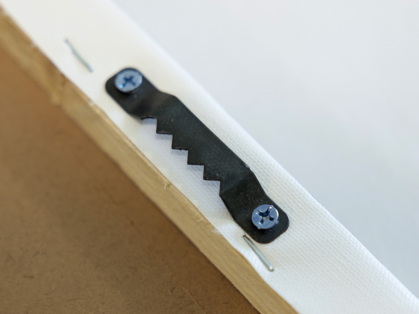 Detail photo showing the pre-installed sawtooth hanger